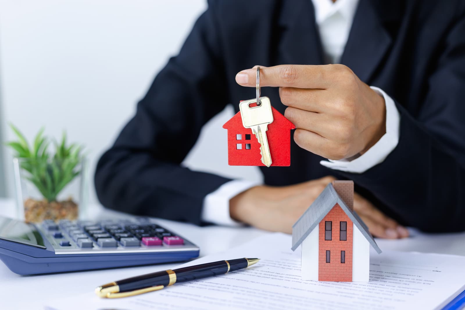 broker-page-image Broker using fix and flip loan referrals holding key with house model